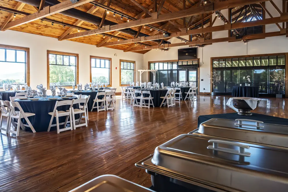 Banquet room arranged with buffet chafing dishes and seating for a catered event